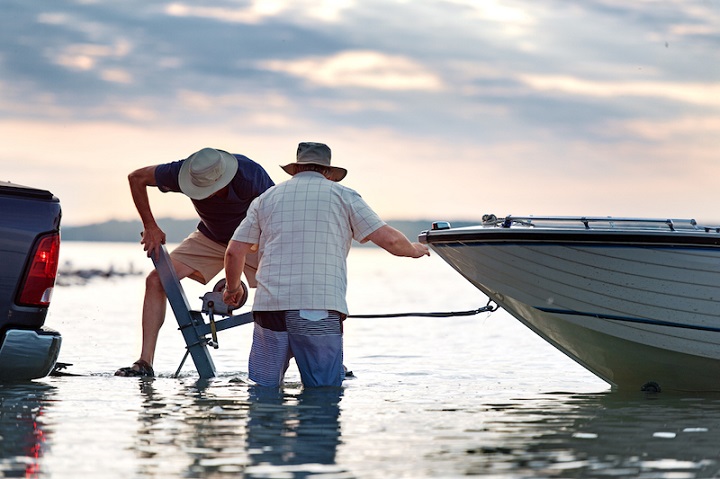 man putting on his boat with a trailer winch